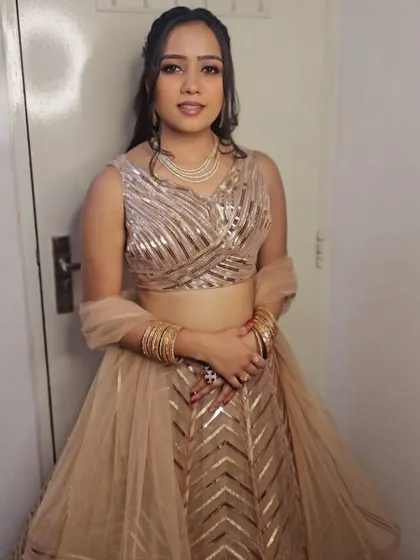 The complete look, with soft makeup and hair that perfectly balances the sparkle of her outfit.