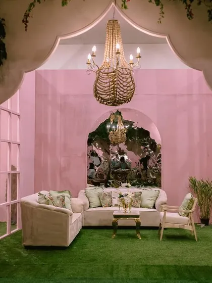 The result of our ballroom transformation for a Mehendi. We created a vibrant indoor garden with a central fountain, chevron-patterned flooring, and cozy seating nooks, proving that any space can become magical.