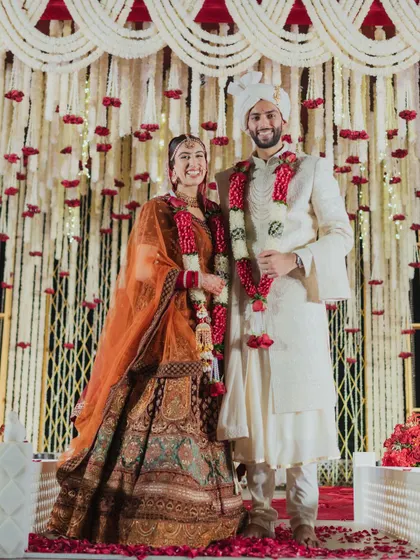 A full-length shot of the couple, showcasing their beautiful wedding attire against the decor. I work to ensure the decor complements the couple's style, creating a cohesive and stunning aesthetic.