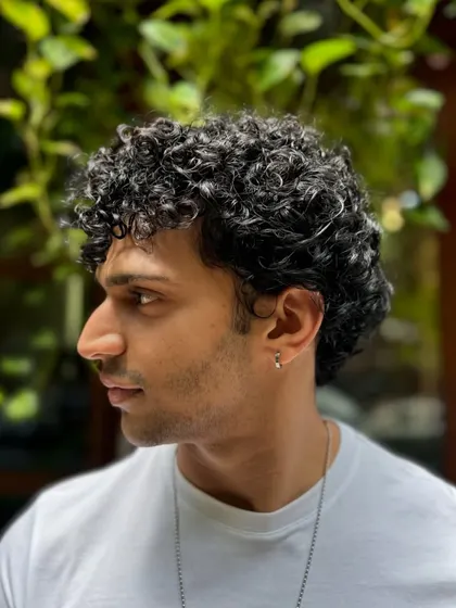 Curls for the win. This client's short, tight curls are perfectly defined and shaped for a stylish, effortless look that's easy to maintain.