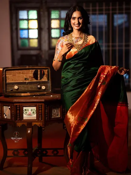 Kaavya Shastry looking joyful and radiant in the green and orange saree, a perfect blend of classic and contemporary styling.