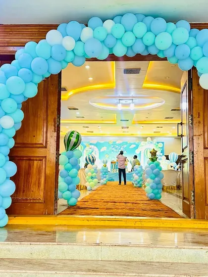 The entrance to the hot air balloon party, featuring a large balloon arch in matching blue tones.