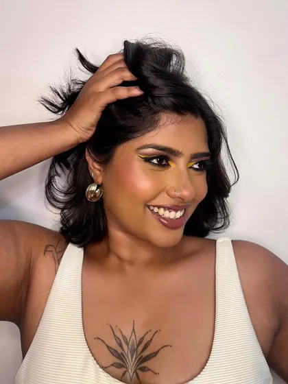 A happy and candid shot of the model enjoying her bold makeup. It's important to me that clients feel confident and have fun with their look.