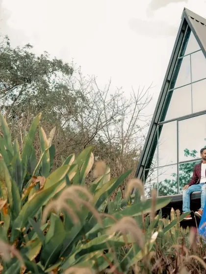 A wide shot of the couple at a modern, A-frame cabin, showcasing our ability to shoot at unique architectural locations.