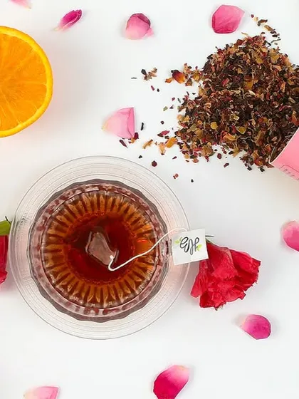 A top-down flat lay is a powerful format for social media and websites. Here, we arranged a brand's rose and lemon tea with its core ingredients and packaging, creating a visually clean and informative shot that tells a story of flavor and quality.