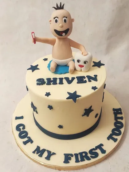 We celebrate a baby's first tooth with this unique and playful cake. A cute baby figure sits with a giant tooth, surrounded by stars, making this a fun and memorable way to commemorate a small but significant milestone.