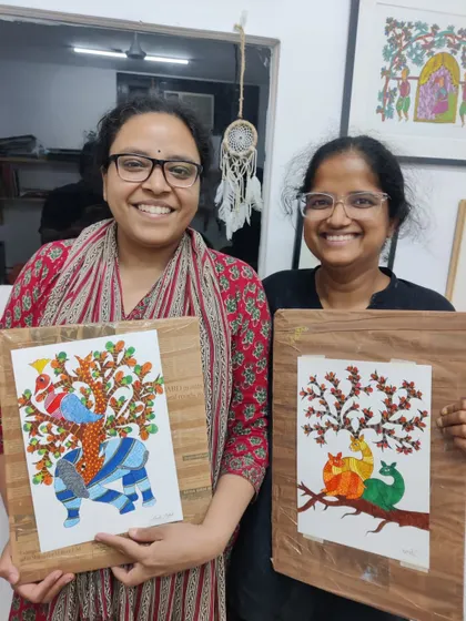 Two participants from our Gond art workshop proudly show their intricate creations. We love exploring traditional Indian art forms and making them accessible to everyone, regardless of prior experience.