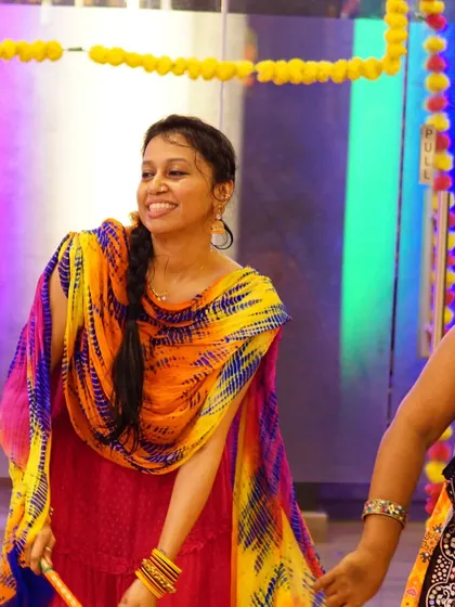 A participant enjoying the rhythm of the music. We select the perfect tracks to match the energy of your Garba or Dandiya night.
