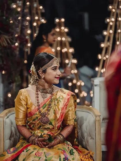 A portrait of the beautiful bride, Rajini, during her traditional Bunt ceremony. The soft lighting from our custom candle installations creates a serene and timeless moment.