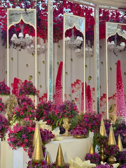 A close-up of the mirrored panels with a traditional arch design, reflecting the chandeliers and the vibrant floral arrangements.
