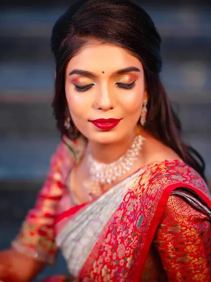 For the reception, we switched to a soft glam look. This features beautiful shimmery eyeshadow that catches the light and a vibrant red lip, paired with a more relaxed hairstyle for an evening of celebration.