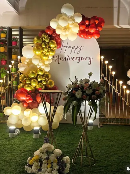 A wider view of the anniversary setup, showing the addition of floral arrangements and decorative lighting.