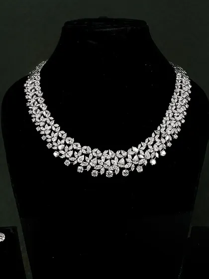 This classic diamond necklace is designed for unforgettable moments. It features floral clusters of round and pear-shaped diamonds that drape beautifully around the neck.