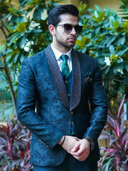 The navy patterned suit looks great against a natural background, making it a versatile choice for day or evening events.