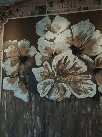 Here, you can see the floral design taking shape. The background texture is complete, and I am building up the layers of the white and gold petals on top.