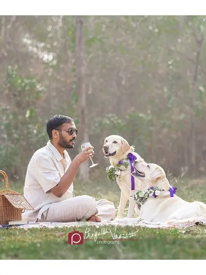 A man sharing a quiet moment with his dog during their picnic. These are the subtle interactions that truly show the depth of the human-animal bond.