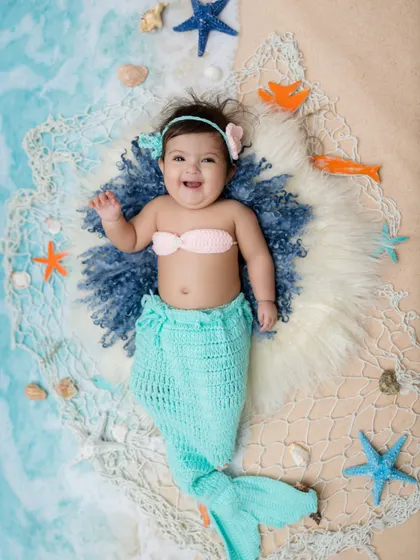 Waving hello from her little ocean scene. This is such a magical theme for a baby photoshoot.