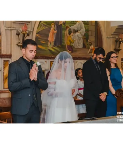 The couple and their best man and maid of honor in a moment of prayer during the church service.
