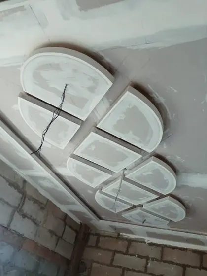 An abstract geometric pattern under construction. This shows how I build up layers of gypsum board to create three-dimensional effects on the ceiling.