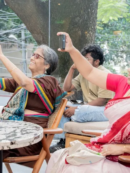 A beautiful moment of connection across generations, as audience members capture memories of the author's reading on their phones.