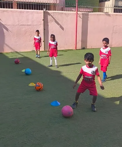 With intense focus, a young player prepares to navigate a cone drill. These exercises are fundamental for developing agility, ball control, and the ability to change direction quickly.