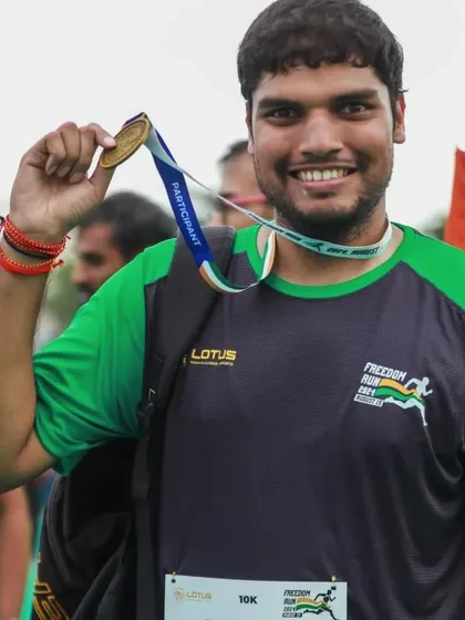 A proud participant shows off his medal after completing the Freedom Run 2024, an event organized by us to celebrate fitness and community.