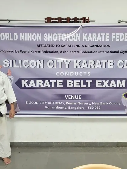 Our Sensei stands before the official banner of the World Nihon Shotokan Karate Federation during a belt exam. We are proud of our affiliation and the high standards it represents.