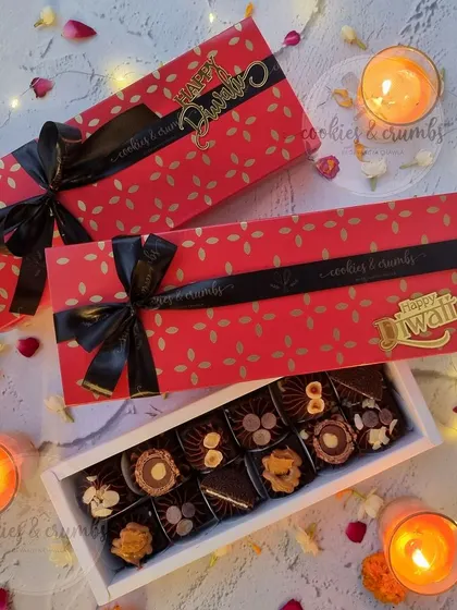 A festive red and gold box filled with my assorted premium chocolates. This was a popular choice for Diwali gifting, tied with a black satin ribbon.