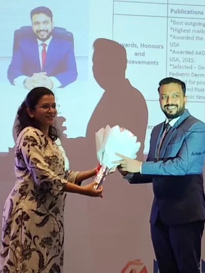 Receiving a token of appreciation after participating in a panel discussion on Urticaria with dermatologists from across the city.