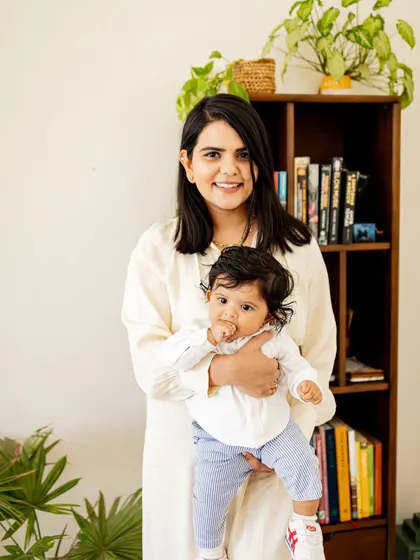 A mother and her baby sharing a happy moment in a classic wooden chair. I love finding unique spots in your home that make for beautiful portraits.