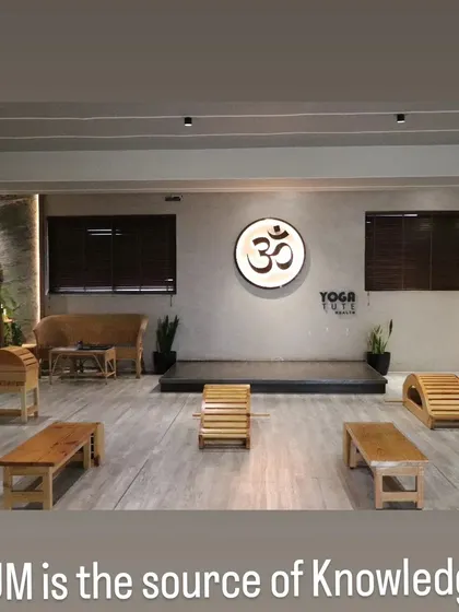 The "Vishwam" classroom, dedicated to Sage Patanjali, is set up with wooden props for a therapy session. This space is designed for deep, restorative work.