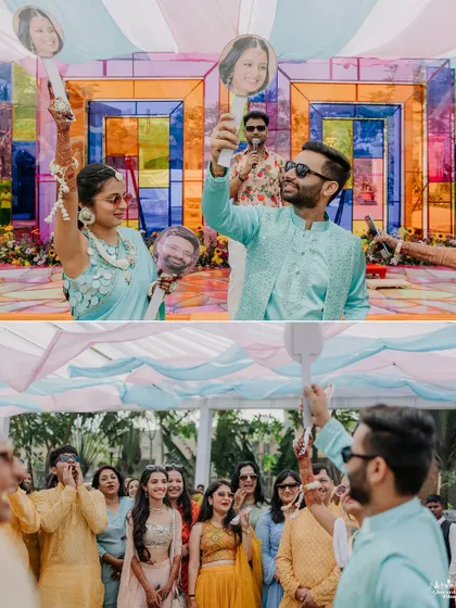 Adding a touch of fun and personalization to the Haldi. The couple holds up paddles with caricature faces of each other, a quirky and cute detail that brings out their playful side.