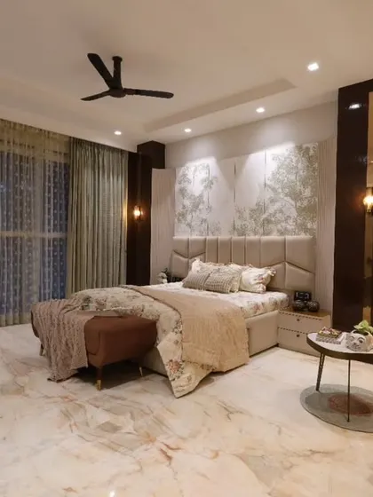 This angle of the master bedroom highlights the beautiful marble flooring and the ample natural light coming through the large windows.