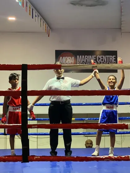 Another gold medal for the academy. A young fighter from our kids' boxing program celebrates her win in the ring. We are proud to have a strong contingent of successful youth boxers.