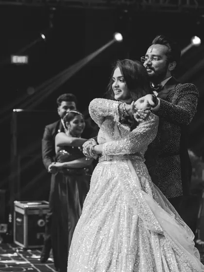 A timeless black and white shot of a couple's performance. The focus is purely on their connection and the beautiful choreography that tells their story.