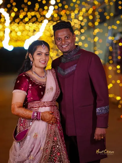 A happy portrait of the couple at their reception, surrounded by festive lights.