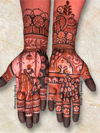This Teej festival mehendi tells a story with a woman on a swing on one palm, and royal swans and peacocks on the other. The design is rich with traditional symbolism.