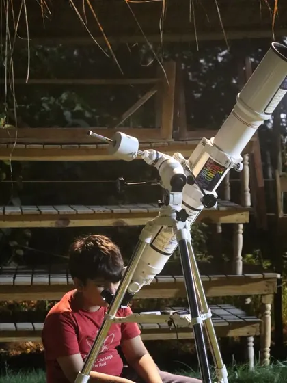 A young boy takes his turn at the telescope during our 'Wonder Journey' event.