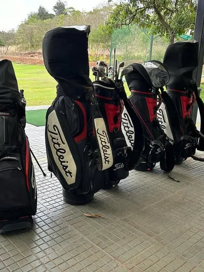 A lineup of Titleist golf bags at our driving range, ready for a weekend of play. We provide quality rental sets if you don't have your own.