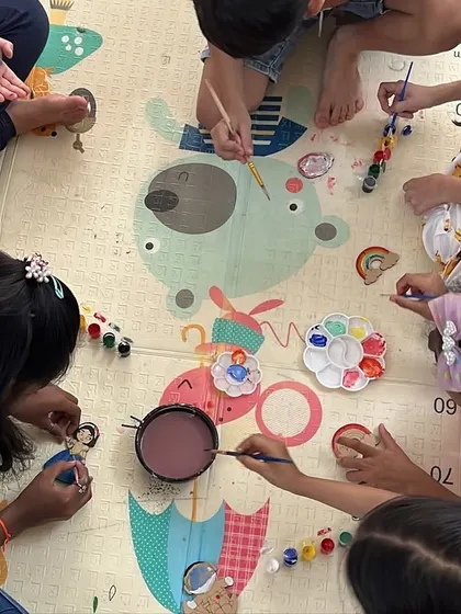 An overhead view of our little artists at work. We set up a comfortable floor-level crafting area so everyone can gather around and create together.