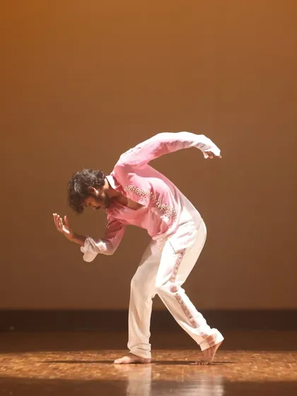 A dynamic contemporary dance pose captured mid-motion. Our classes focus on building a strong foundation to execute such powerful and controlled movements.