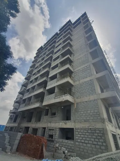 A duplicate image from the construction site, capturing the scale of the apartment project from a low angle.