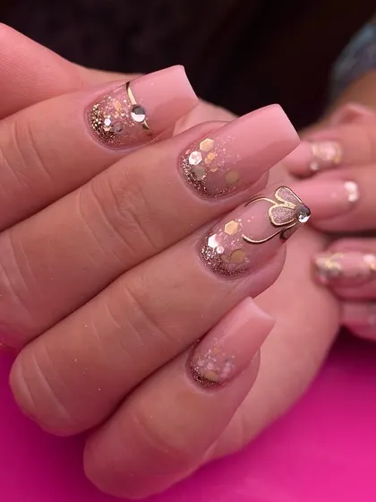 All that glitters is gold. This luxurious set features a sheer pink base on square nails, adorned with sparkling gold glitter and a delicate, 3D gold wire butterfly accent.