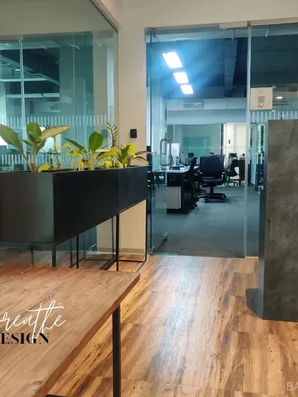 Bringing the outdoors in. We used a combination of wood tones, grey surfaces, and indoor planters to create a refreshing and productive office environment.