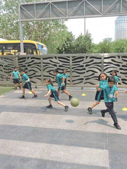 Students enjoying a lively game of dodgeball outdoors, learning about teamwork and sportsmanship while staying active.