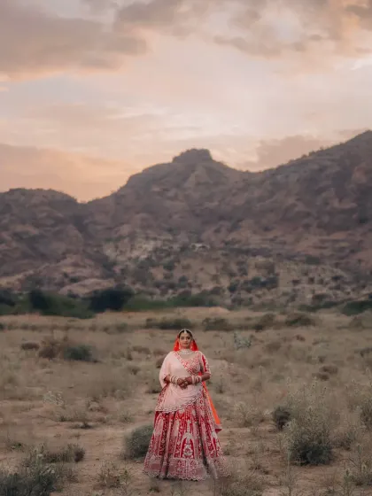 A bride standing alone against a majestic mountain range. This portrait emphasizes the beauty of the natural landscape and the bride's connection to it.