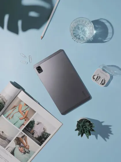 A clean and organized flatlay of the realme Pad Mini. The light blue background and careful placement of accessories create a calm and productive aesthetic.