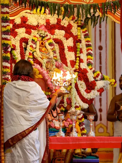 I am performing aarti to the main deity during the Shat Chandi Homa. The entire hall is filled with the divine energy of the Divine Mother.