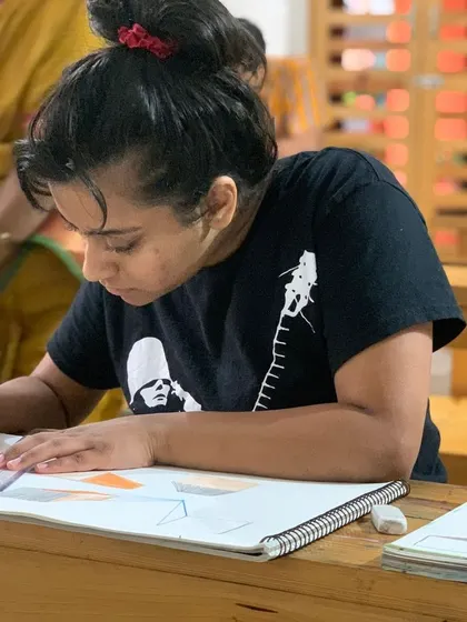 With guidance from our instructor, a student practices perspective drawing, a key skill for any aspiring artist.