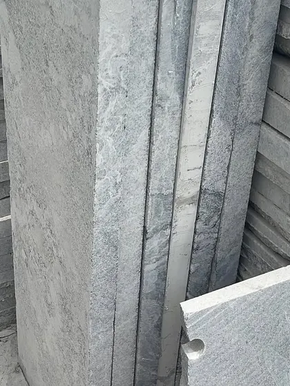 Stacks of finished stone slabs, showing the clean, cut edges.